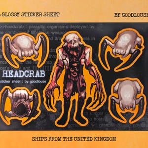 May include: A6 glossy sticker sheet with Headcrab designs. The sheet features multiple stickers with a central humanoid figure and several crab-like creatures in shades of brown, red, and black, with an orange outline.