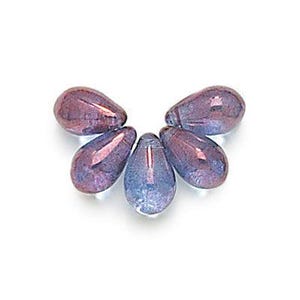May include: Six iridescent glass teardrop beads in shades of purple and blue.