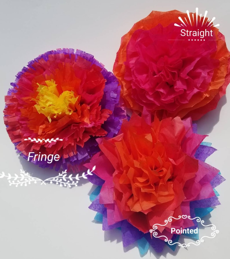 May include: Three colorful tissue paper flowers in shades of red, orange, yellow, purple, and blue. The flowers have different edge styles: fringe, straight, and pointed. These decorative flowers are perfect for party decorations.