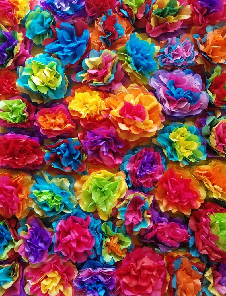 May include: A vibrant display of colorful paper flowers in shades of red, orange, yellow, green, blue, and purple. The flowers are arranged closely together, creating a textured and visually rich background. The image showcases a festive and celebratory theme.