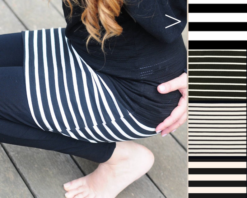 May include: A black and white striped skirt with a black top. The top has a small white arrow on the front.
