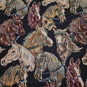 May include: A tapestry featuring a repeating pattern of horse heads in various colors, including brown, tan, and cream, with detailed bridles and manes. The background is black, creating a striking contrast. The horses are facing different directions.