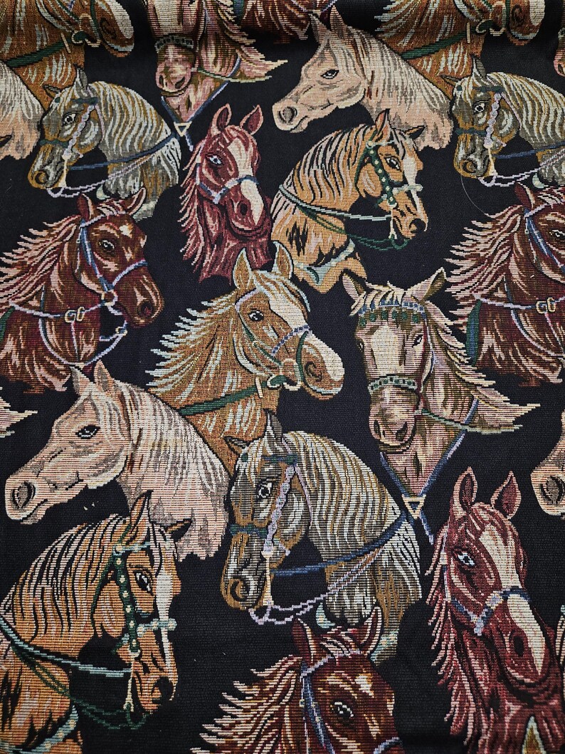 May include: A tapestry featuring a repeating pattern of horse heads in various colors, including brown, tan, and cream, with detailed bridles and manes. The background is black, creating a striking contrast. The horses are facing different directions.