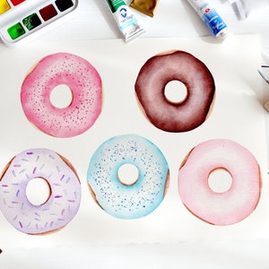 May include: Five watercolor donuts on a white background. The donuts are pink, brown, purple, blue, and light pink. Each donut has a different type of sprinkle on top.