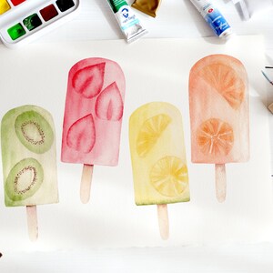 May include: Watercolor painting of four popsicles on a white background. The popsicles are made with kiwi, strawberry, lemon, and orange. The painting is surrounded by paint tubes and brushes.