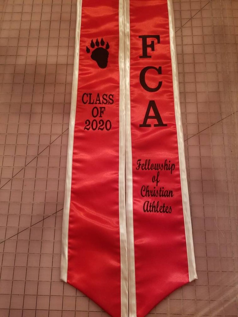 May include: Red and white graduation sash with the text "FCA Fellowship of Christian Athletes" and "Class of 2020" with a black paw print.
