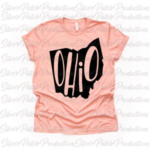 May include: A peach-colored t-shirt with a black outline of the state of Ohio and the word "Ohio" written in black inside the outline.