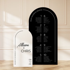 May include: Black and white wedding seating chart with an arch design. The chart lists guest names and table numbers. The text "Our Favorite People" is at the top of the chart. The text "Allison + Chris" is on the white side of the chart.
