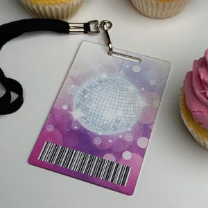 Custom acrylic VIP pass with disco ball design and barcode attached to a black lanyard for a party favor