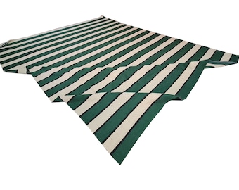 May include: A green and white striped fabric, possibly a tablecloth or awning material, is displayed against a white background. The fabric is folded, showcasing the alternating stripes. The stripes are a medium width and run the length of the fabric.