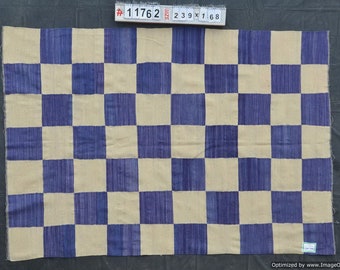 May include: A rectangular rug with a checkerboard pattern. The design features alternating squares of beige and blue. The rug's dimensions are approximately 7.8 feet by 2.5 feet.