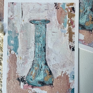 May include: A teal blue glass vase with a textured surface sits on a background of abstract brushstrokes in shades of pink, brown, and white. The vase is tall and slender with a rounded base.