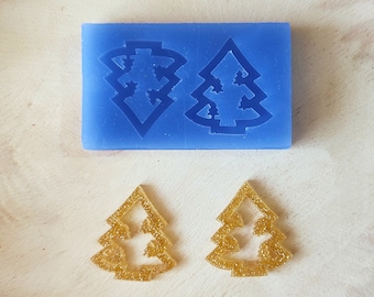 May include: Two gold glitter Christmas tree decorations and a blue silicone mould with two Christmas tree shapes.