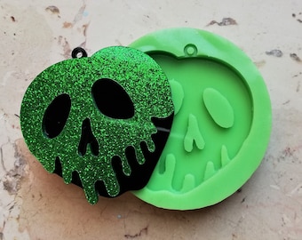 May include: Green glitter skull shaped resin mold and a finished resin piece with a green glitter skull design. The mold is made of silicone and has a hole at the top for hanging.