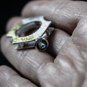Contemporary ring with reticulated sterling silver and keum boo 24k gold foil and blue topaz stone, double-sided. In Hand.