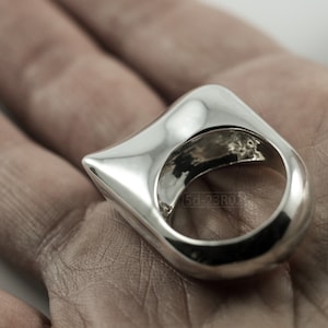 Contemporary Massive Modern Ring in Sterling Silver with Curves and High Shine, Cushion Like Shape. On Palm.