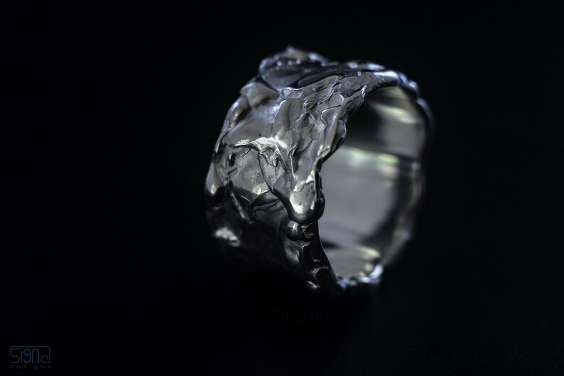 Molten Metal Chunky Ring, Dramatic Jewellery for Men and Women, Unisex Broad Ring with Irregular Edges. On Black Background.