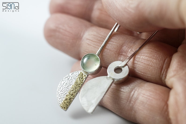Reticulated Silver Earrings with 24k Keum-Boo Gold Foil and Prehnite Cabochons, Organic and Contemporary. Reticulated Half Oval Shape with a Stripe of Gold Leaf and Long Ear Wires. In hand. One with front, the other with the back view.