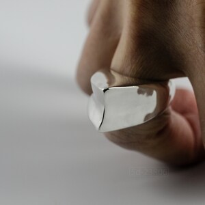 Geometric Ring, Contemporary Design, Massive, Bold and Unisex, with High Shine Finish. On finger, white background.