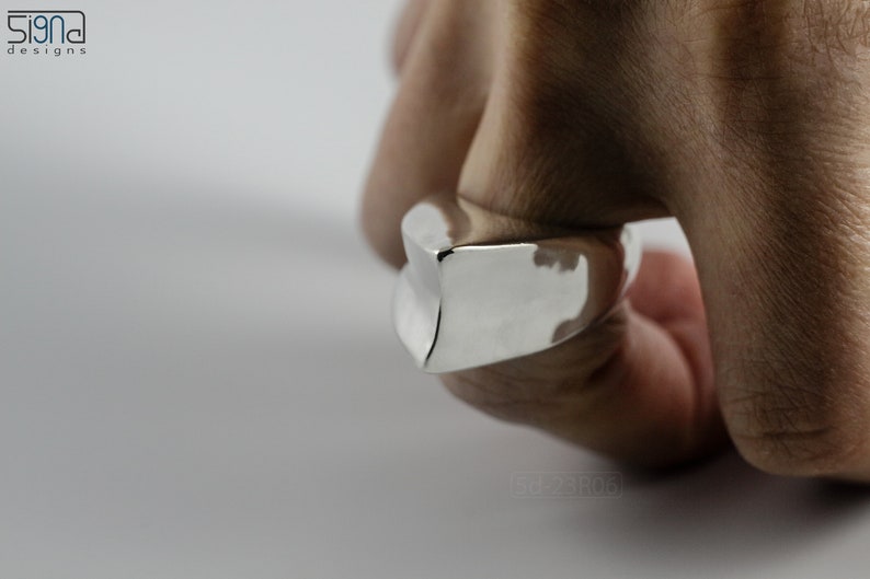 Geometric Ring, Contemporary Design, Massive, Bold and Unisex, with High Shine Finish. On finger, white background.