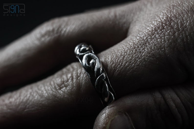 Primitive, raw, organic unisex sterling silver ring with twisted design and patina. On Finger.