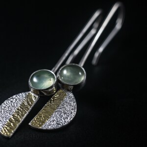 Reticulated Silver Earrings with 24k Keum-Boo Gold Foil and Prehnite Cabochons, Organic and Contemporary. Reticulated Half Oval Shape with a Stripe of Gold Leaf and Long Ear Wires. On black background.