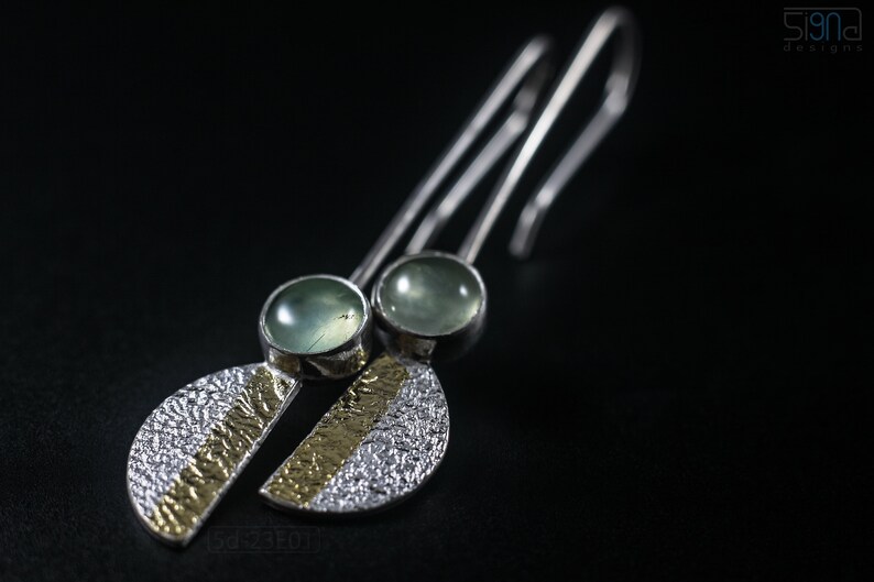 Reticulated Silver Earrings with 24k Keum-Boo Gold Foil and Prehnite Cabochons, Organic and Contemporary. Reticulated Half Oval Shape with a Stripe of Gold Leaf and Long Ear Wires. On black background.