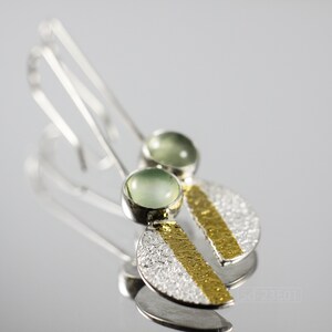 Reticulated Silver Earrings with 24k Keum-Boo Gold Foil and Prehnite Cabochons, Organic and Contemporary. Reticulated Half Oval Shape with a Stripe of Gold Leaf and Long Ear Wires. On mirror surface and bright background.