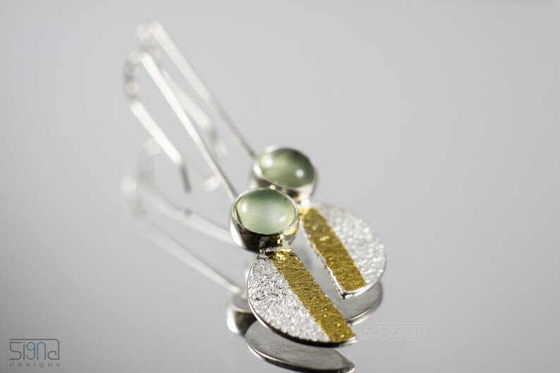 Reticulated Silver Earrings with 24k Keum-Boo Gold Foil and Prehnite Cabochons, Organic and Contemporary. Reticulated Half Oval Shape with a Stripe of Gold Leaf and Long Ear Wires. On mirror surface and bright background.