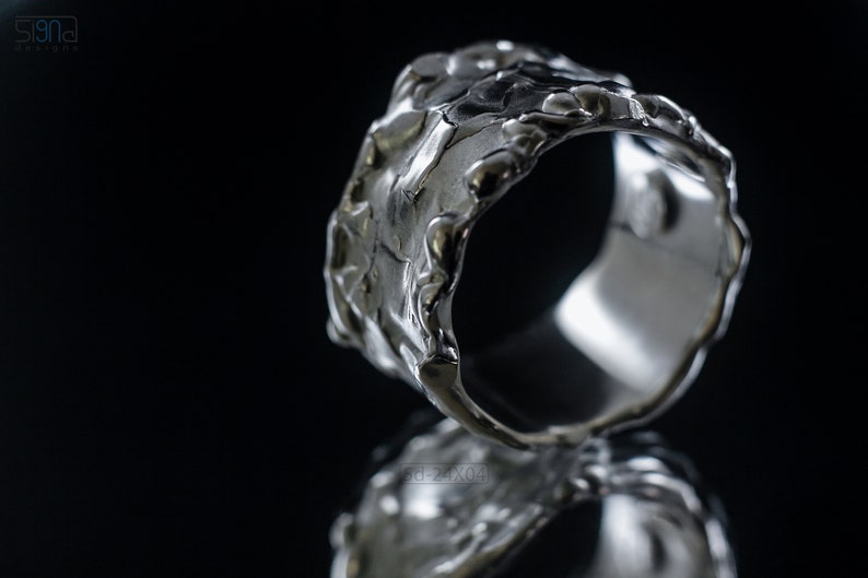 Molten Metal Chunky Ring, Dramatic Jewellery for Men and Women, Unisex Broad Ring with Irregular Edges. On Black Background with Mirror Reflection from Underneath.