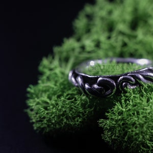 Primitive, raw, organic unisex sterling silver ring with twisted design and patina. On Green Moss.