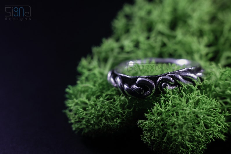 Primitive, raw, organic unisex sterling silver ring with twisted design and patina. On Green Moss.