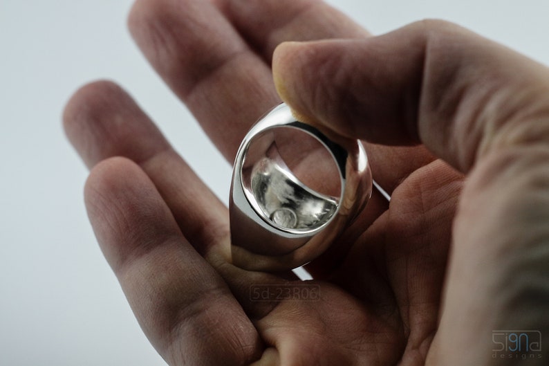 Geometric Ring, Contemporary Design, Massive, Bold and Unisex, with High Shine Finish. Inside detail. In hand, white background.