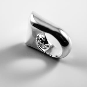Contemporary Massive Modern Ring in Sterling Silver with Curves and High Shine, Cushion Like Shape. On White Background.