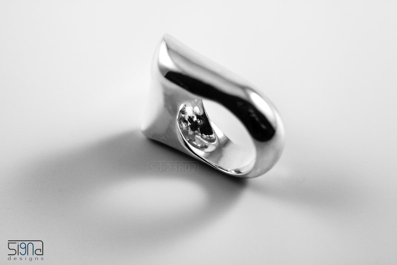 Contemporary Massive Modern Ring in Sterling Silver with Curves and High Shine, Cushion Like Shape. On White Background.