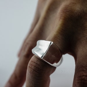 Geometric Ring, Contemporary Design, Massive, Bold and Unisex, with High Shine Finish. On finger, white background.