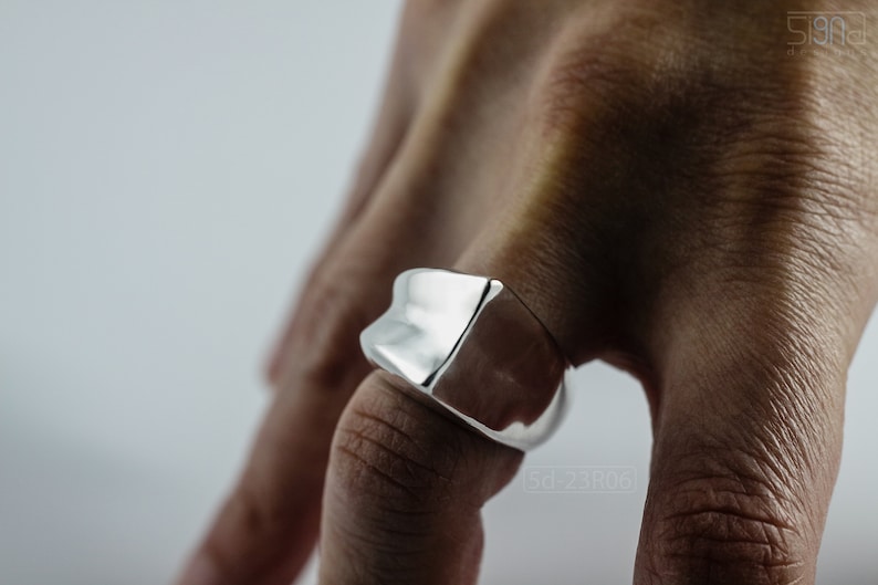 Geometric Ring, Contemporary Design, Massive, Bold and Unisex, with High Shine Finish. On finger, white background.
