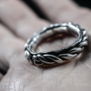 Primitive, raw, organic unisex sterling silver ring with twisted design and patina. In hand
