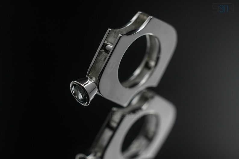 Contemporary ring with reticulated sterling silver and keum boo 24k gold foil and blue topaz stone, double-sided. On Mirror on Black Background.