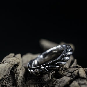 Primitive, raw, organic unisex sterling silver ring with twisted design and patina. On Dry Cactus Wood.