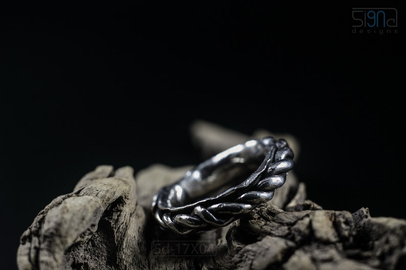 Primitive, raw, organic unisex sterling silver ring with twisted design and patina. On Dry Cactus Wood.