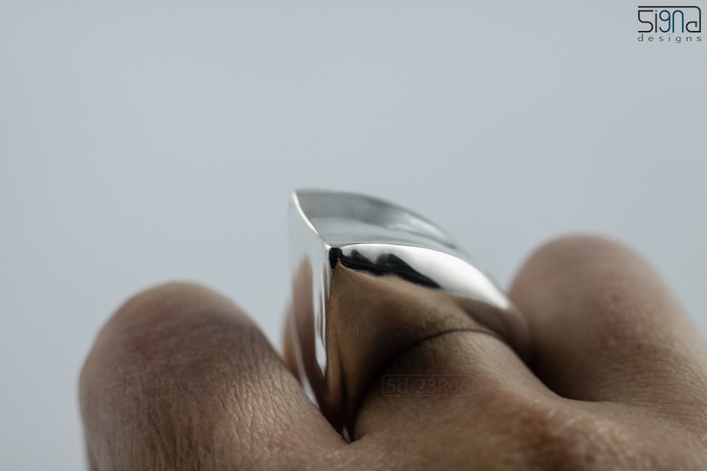 Geometric Ring, Contemporary Design, Massive, Bold and Unisex, with High Shine Finish. On finger, white background.