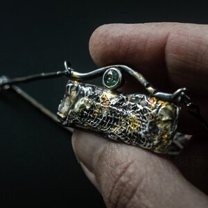 Mixed Metal Organic Necklace with Greenish Blue Sapphire and Topaz, Dark Texture, Statement Edgy Asymmetrical Chain, Silver and Gold Accents. In Hand. Detail.