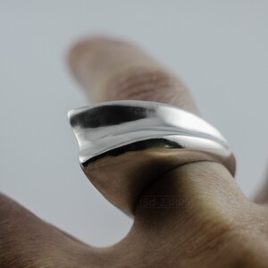 Geometric Ring, Contemporary Design, Massive, Bold and Unisex, with High Shine Finish. On finger, with white background.