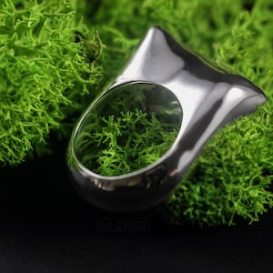 Contemporary Massive Modern Ring in Sterling Silver with Curves and High Shine, Cushion Like Shape. On Green Moss.