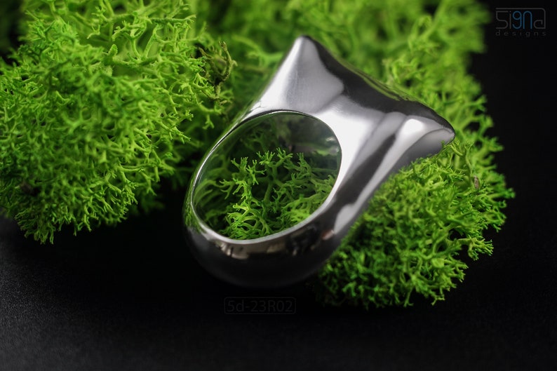 Contemporary Massive Modern Ring in Sterling Silver with Curves and High Shine, Cushion Like Shape. On Green Moss.