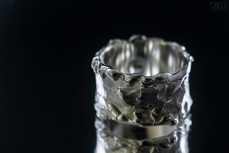 Molten Metal Chunky Ring, Dramatic Jewellery for Men and Women, Unisex Broad Ring with Irregular Edges. On Black Background with Mirror Reflection from Underneath.