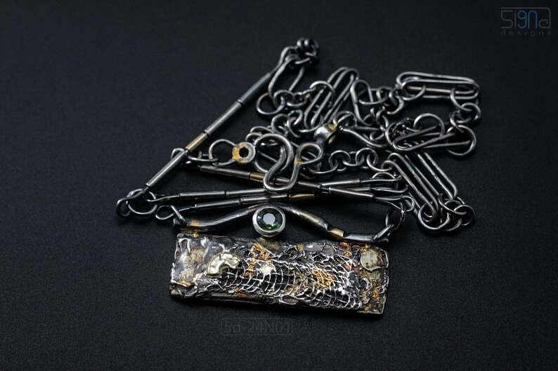Mixed Metal Organic Necklace with Greenish Blue Sapphire and Topaz, Dark Texture, Statement Edgy Asymmetrical Chain, Silver and Gold Accents. On Black Background.