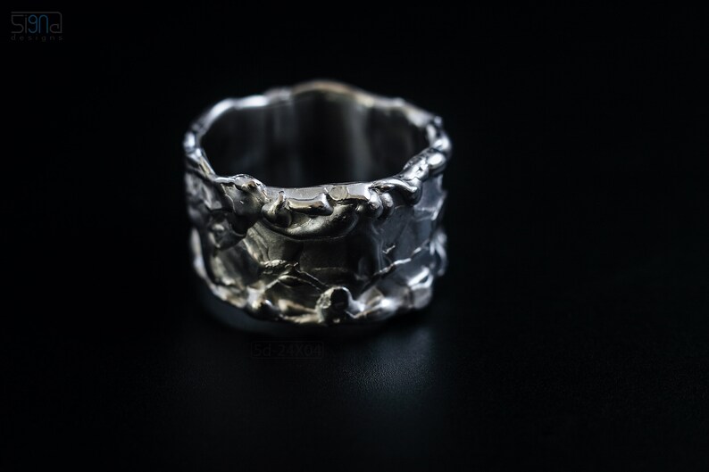 Molten Metal Chunky Ring, Dramatic Jewellery for Men and Women, Unisex Broad Ring with Irregular Edges. On Black Background.