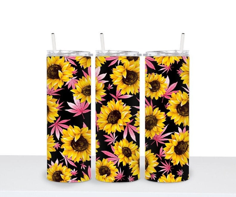 May include: Three stainless steel tumblers with a black background and a floral pattern of pink leaves and yellow sunflowers.